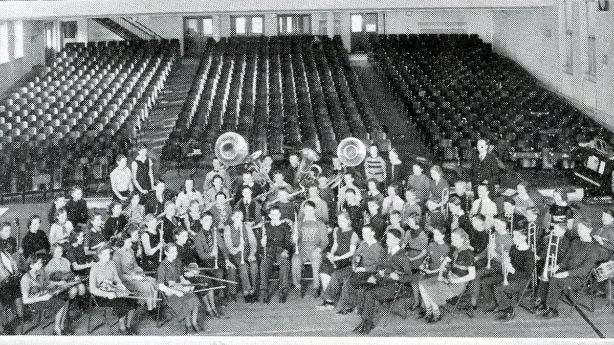 Historic photo: school band in the auditorium with the original seating