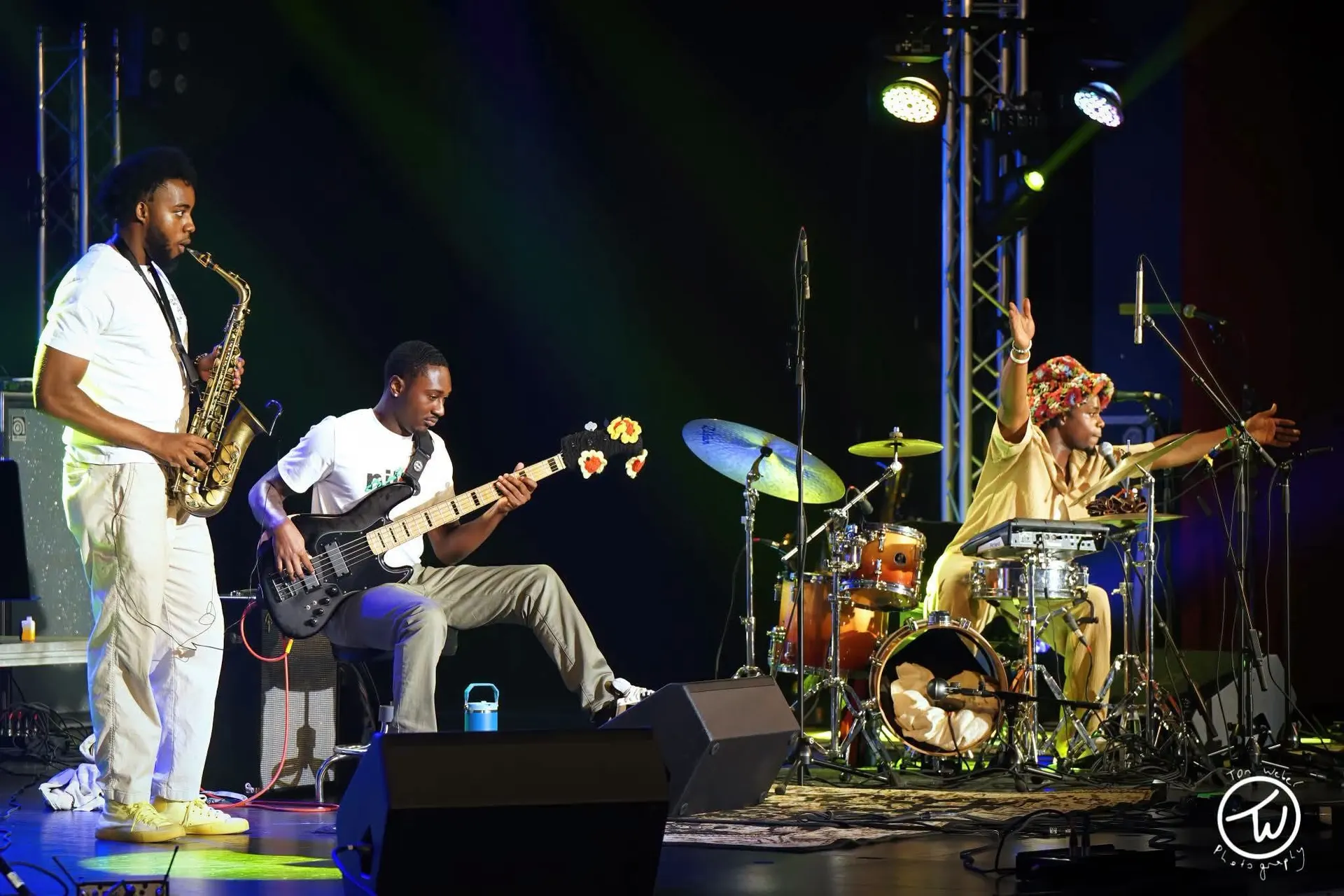 Sax, bass and drums trio on stage