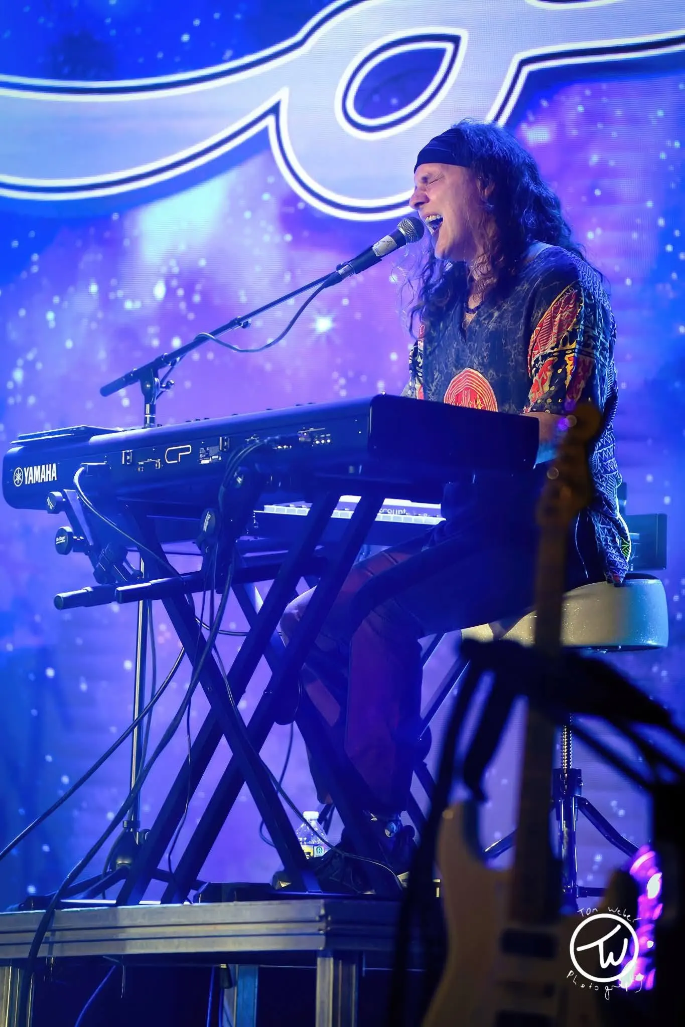 Keyboard player singing, vertical crop